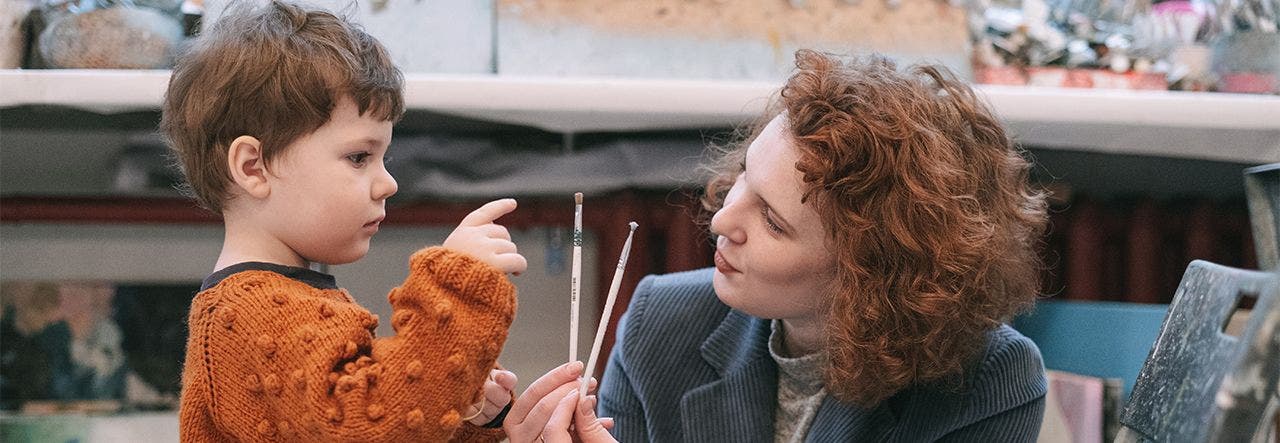 Mother and toddler picking out paint brushes for non-toxic crafts