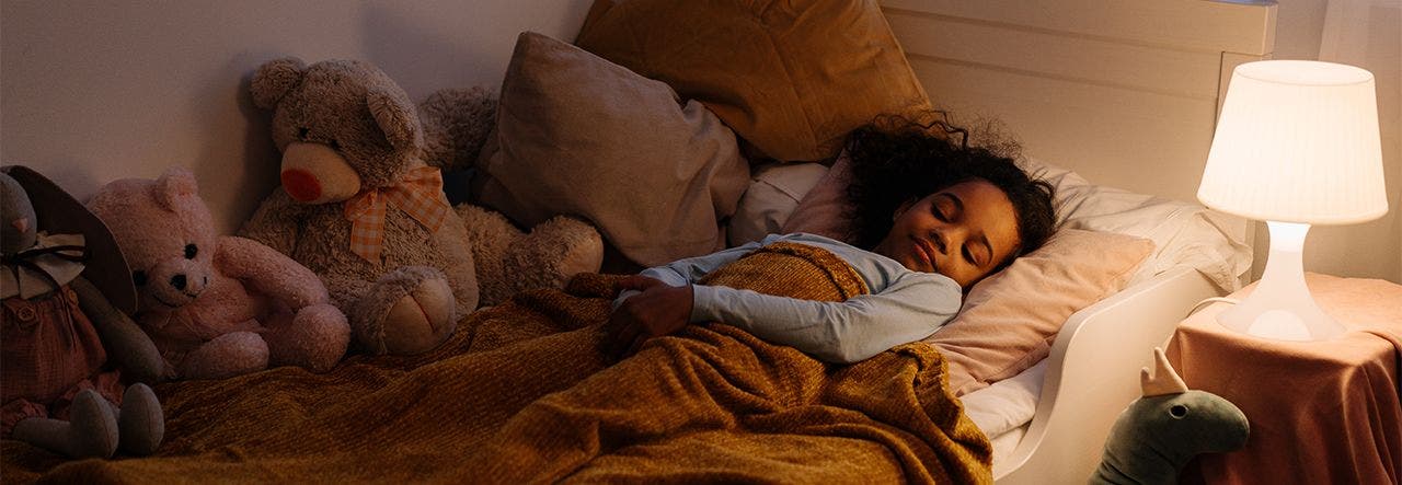 Young girl sleeping soundly in a big kid bed