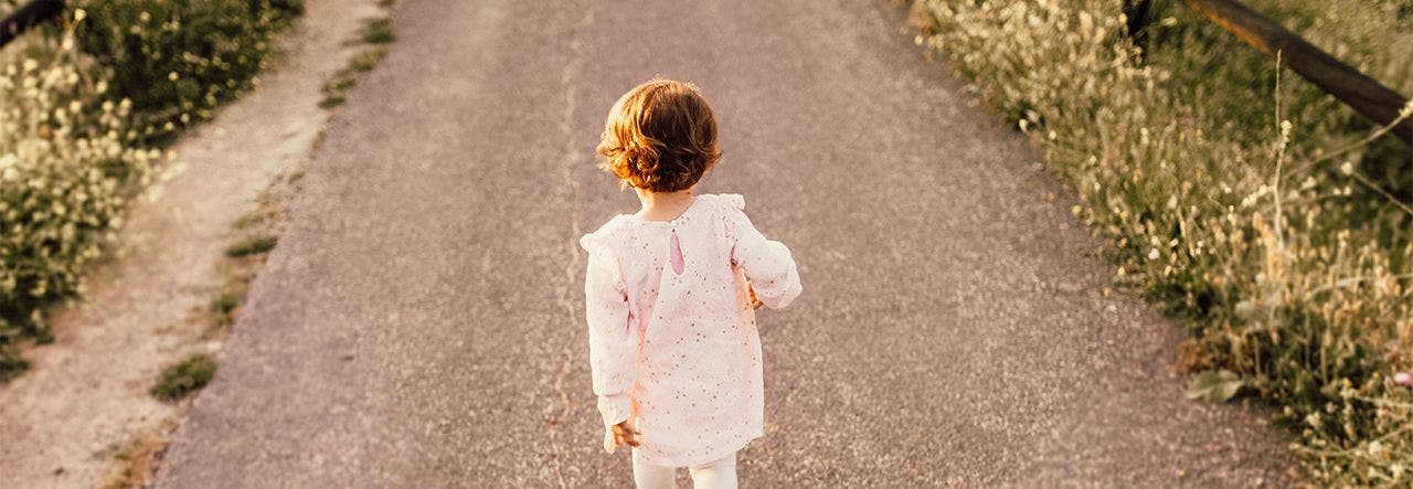 Toddler walking outside enjoying the fresh air