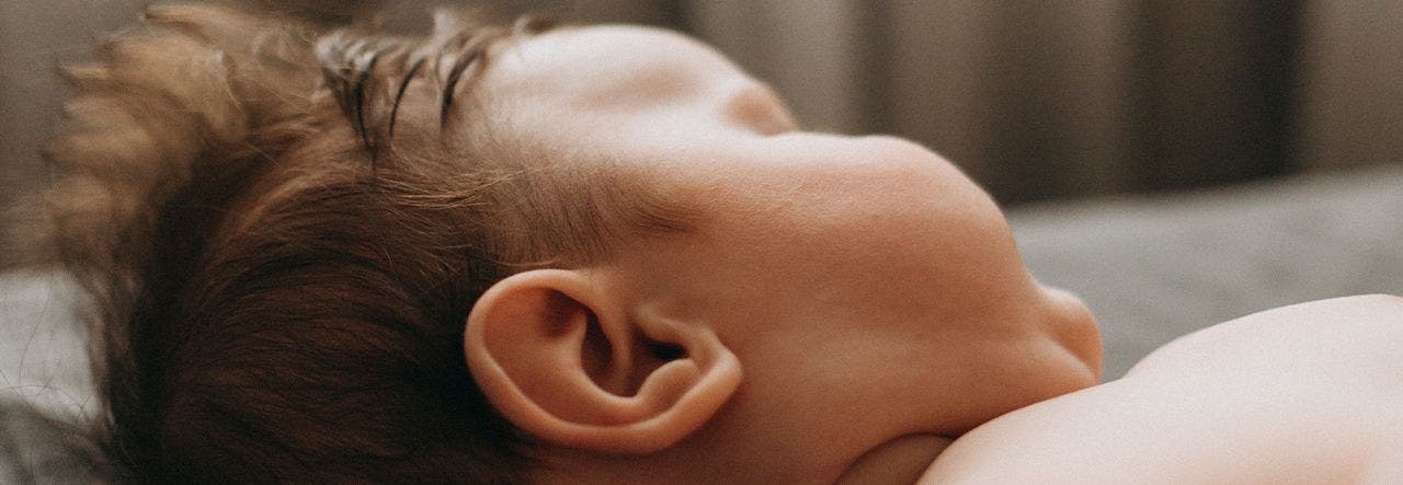 Baby lying on back and napping