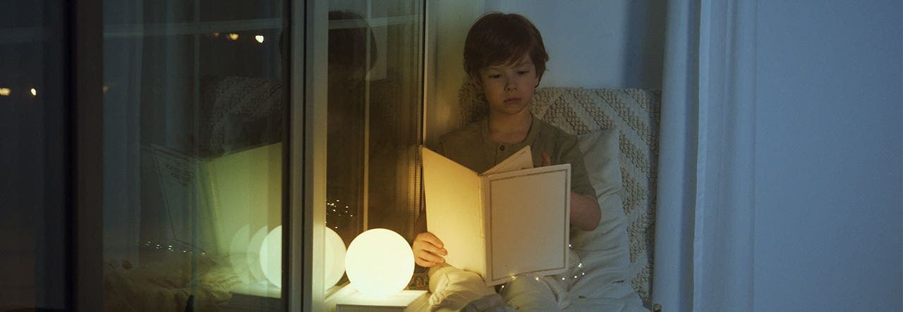 Young child looking at a book at bedtime