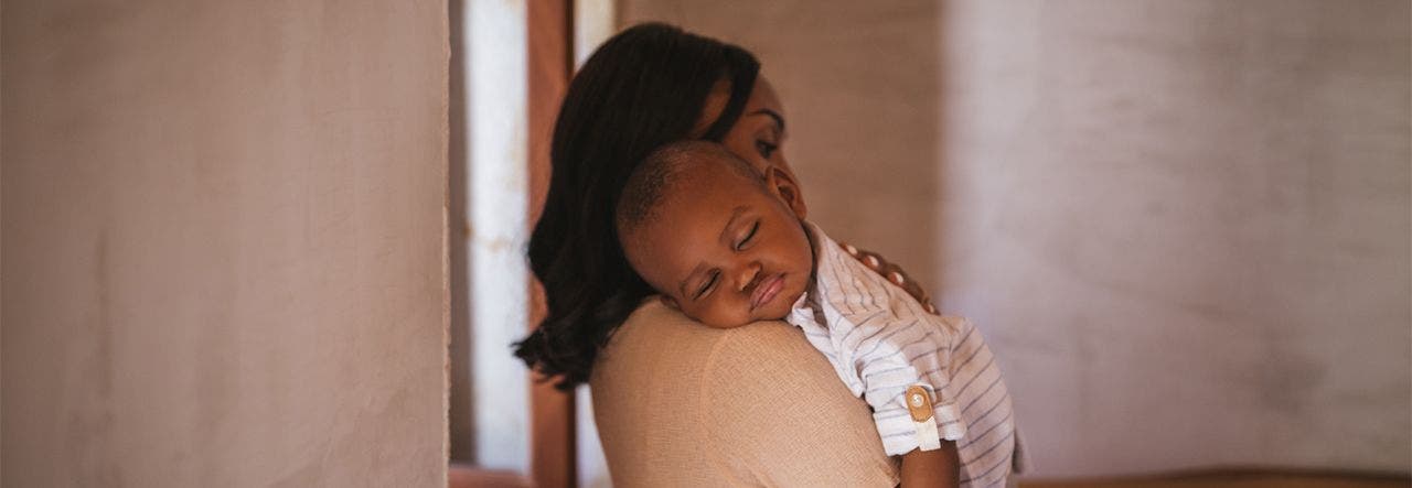 Toddler sleeps in mother's arms