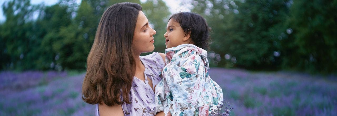 woman holding child in lavender field