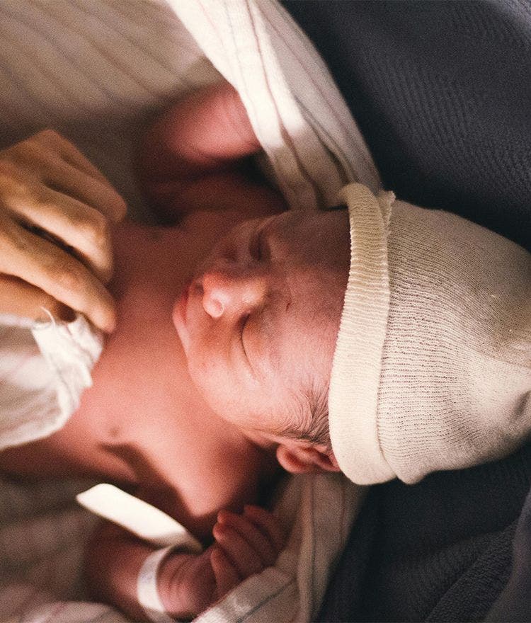 newborn sleeping with hat and blanket