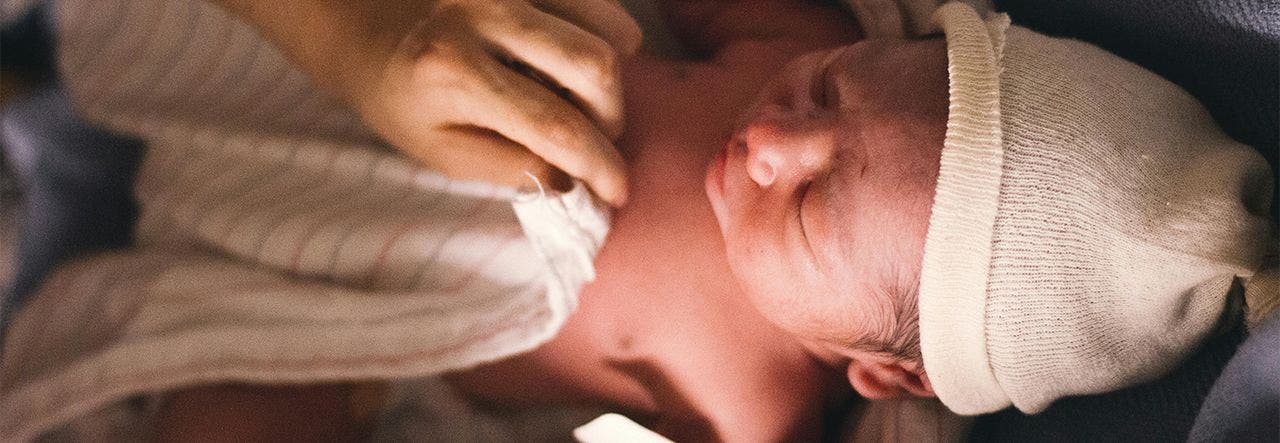 newborn sleeping with hat and blanket
