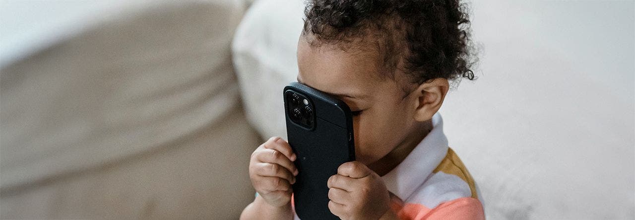 toddler holding phone