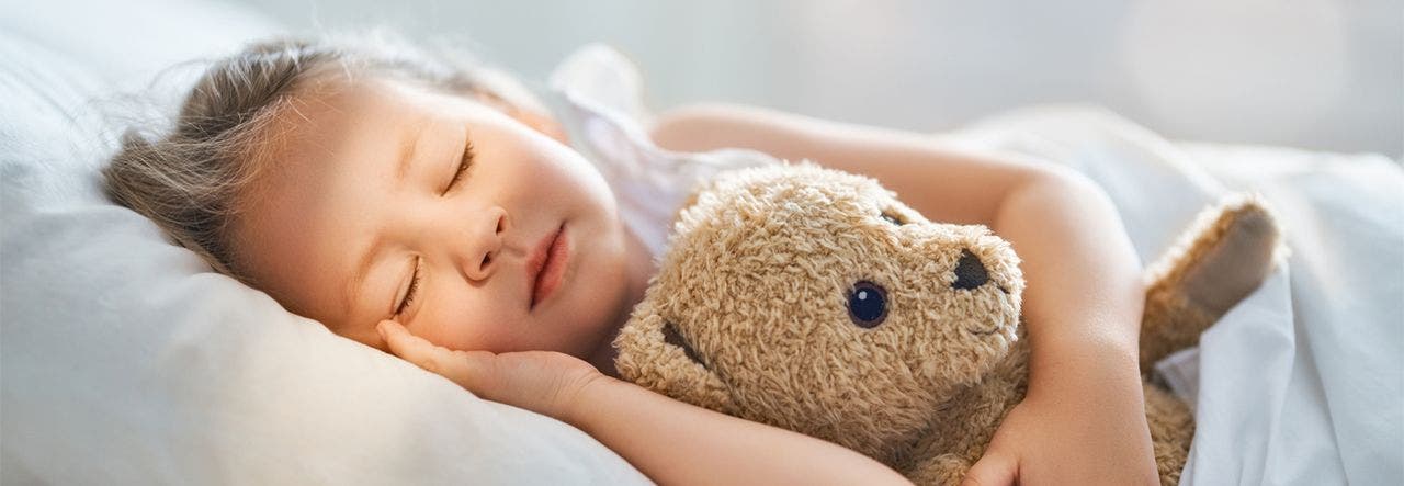 little girl sleeping with teddy bear