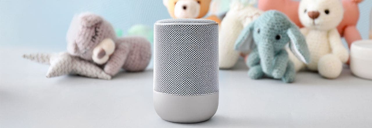 white noise machine in baby nursery with stuffed toys in background
