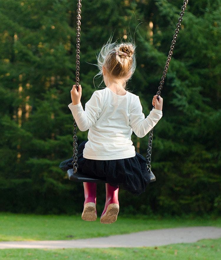 child on a swing outside
