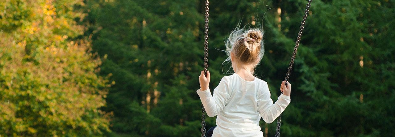 child on a swing outside