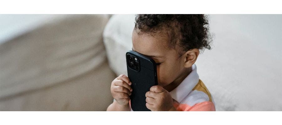 toddler holding phone