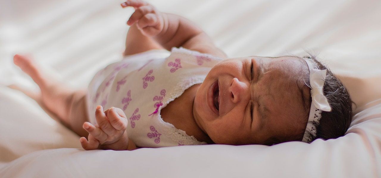 Infant lying on her back and crying