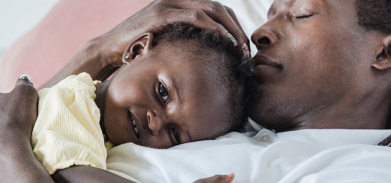 Sleepy father and daughter snuggling together