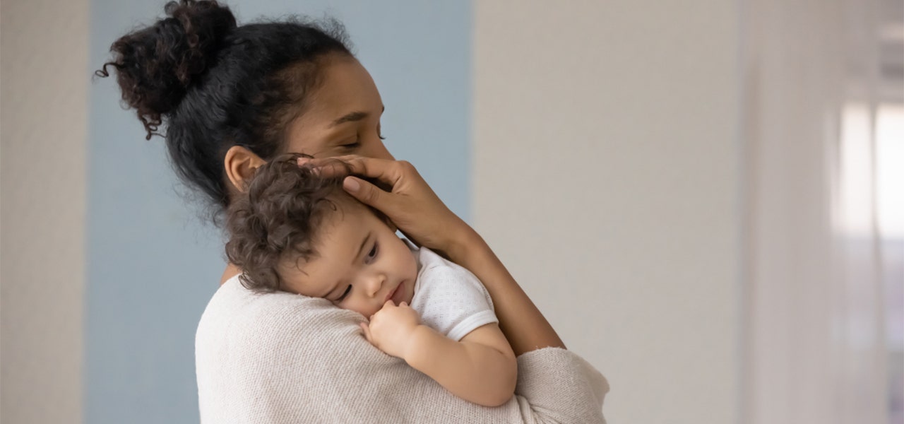 Mother holding baby and pacing when baby won't sleep