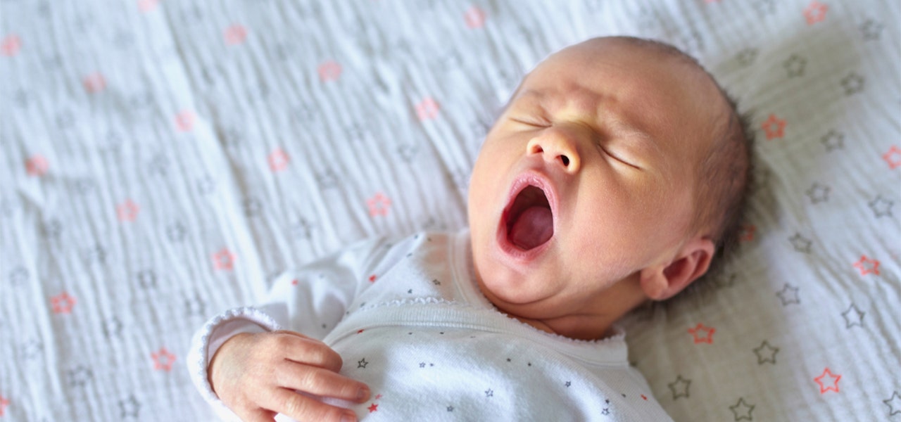 Infant yawning and showing signs of being tired