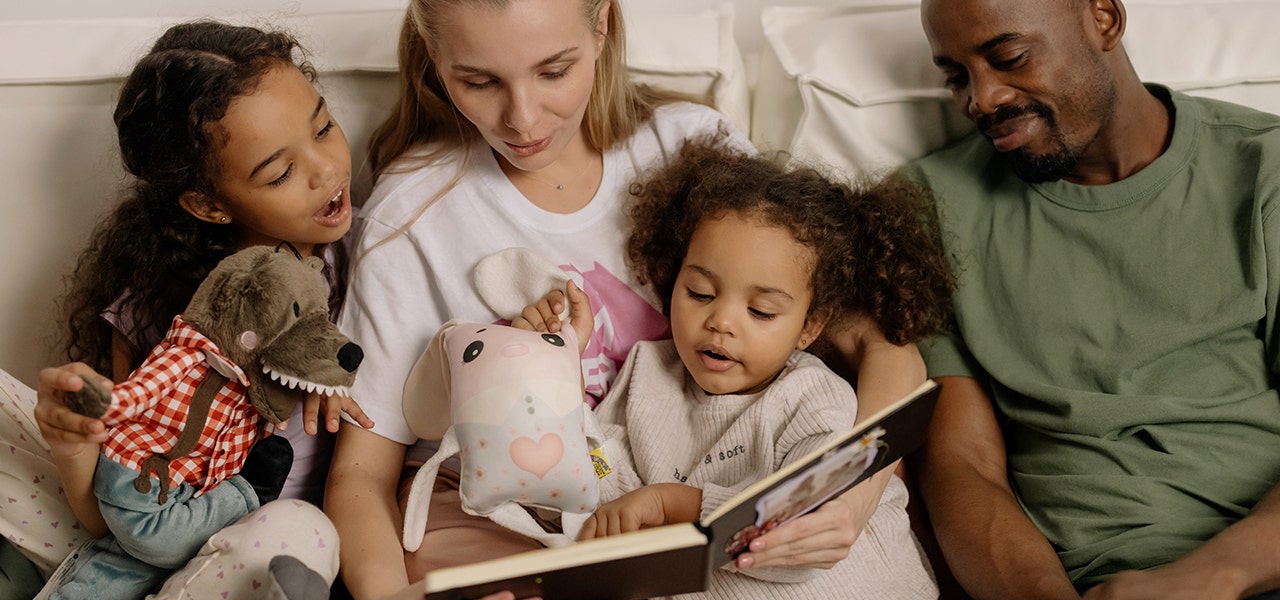 Mom and Dad reading a bedtime story to their two children