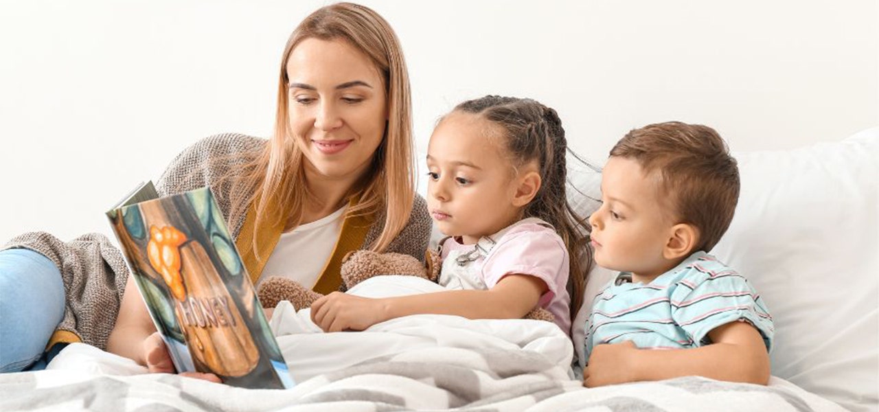 Mom and two small children snuggling during a bedtime story