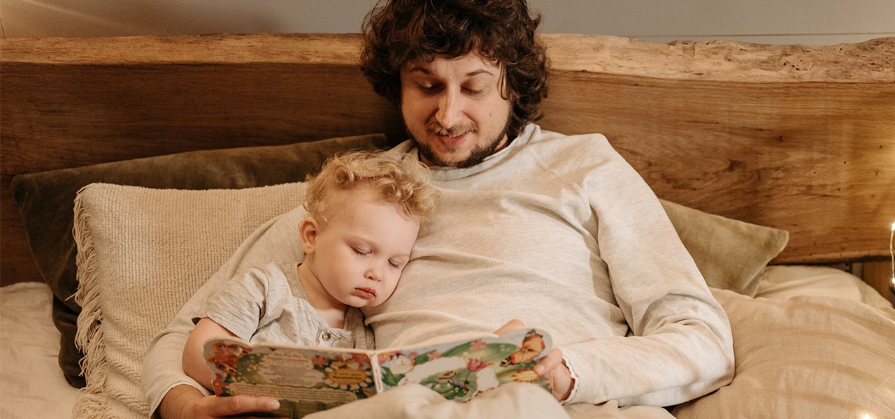 Father reading bedtime stories to his toddler