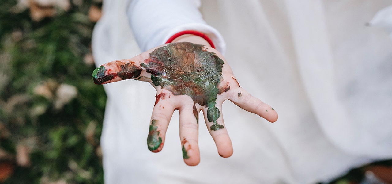 Toddler's hand covered in non-toxic paint