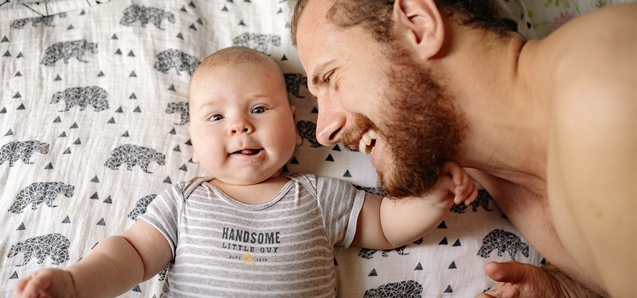 Father and baby snuggling on non-toxic bedding free of flame retardants