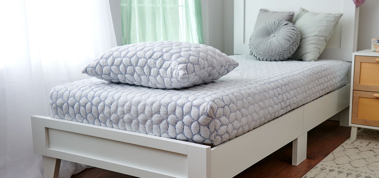 Big kid bed set up with Lullaby Earth non-toxic kids mattress and pillow
