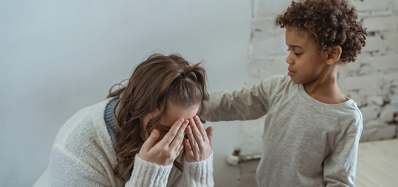 Small child comforting his overwhelmed mom