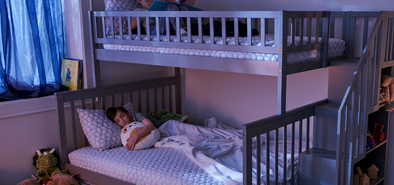 Two kids in their bunk beds with non-toxic mattresses