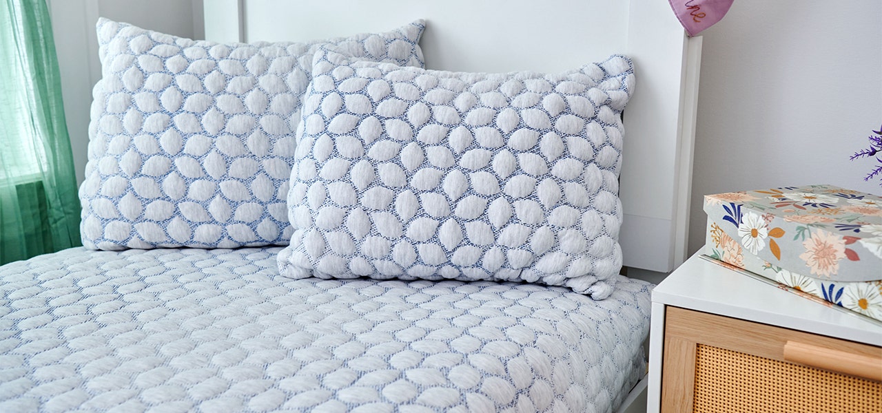 Lullaby Earth non-toxic kids pillows on a fresh, clean bed