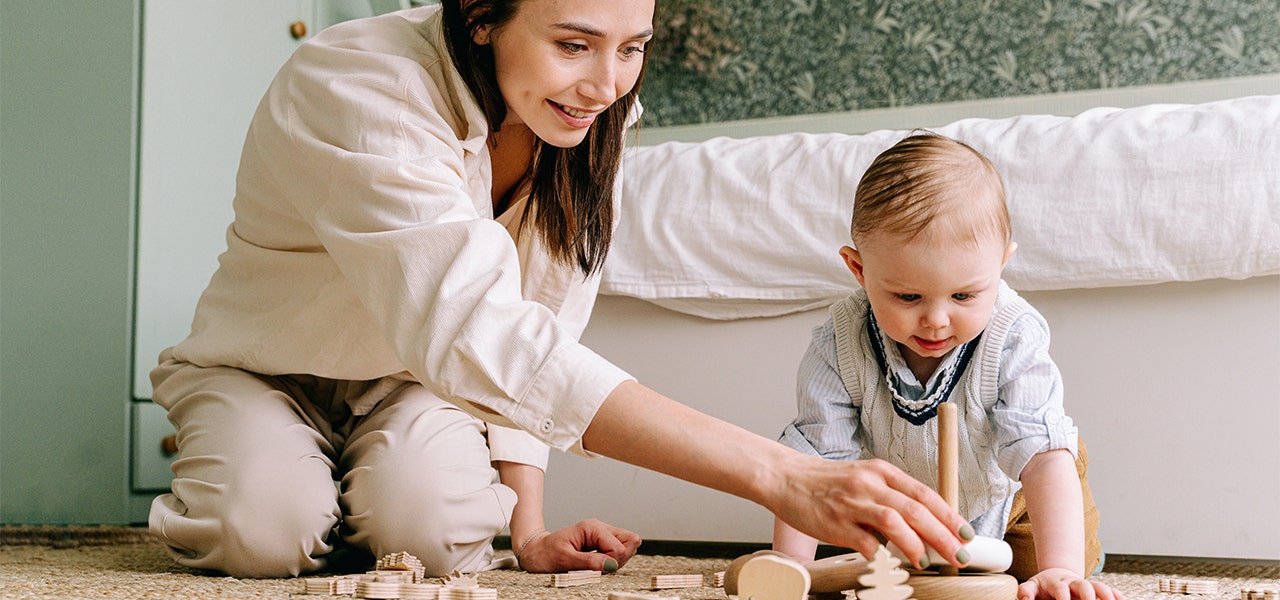 Mother and baby playing with non-toxic wooden toys