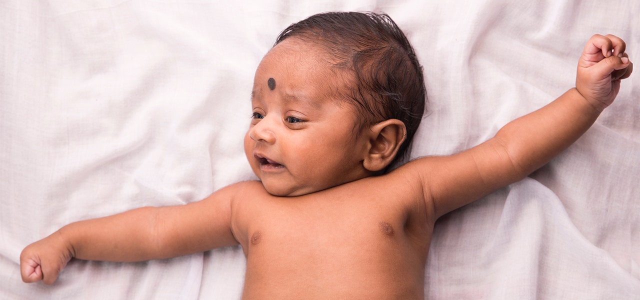 Baby lying down in just a diaper after a calming bath