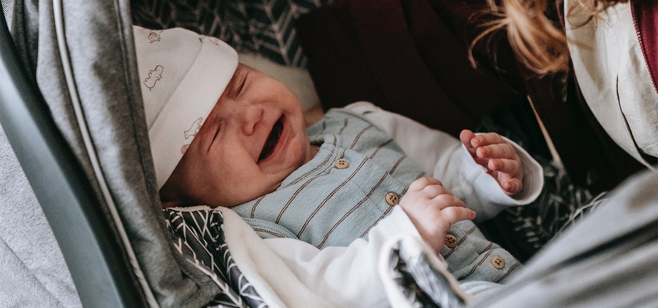 Fussy baby crying in their stroller
