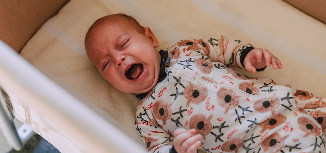 Baby awake and crying in the bassinet