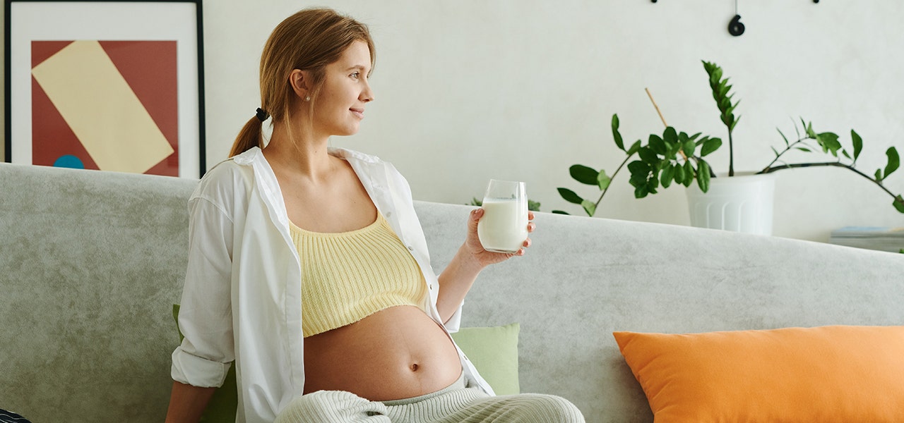 Pregant woman drinking milk to promote sleep