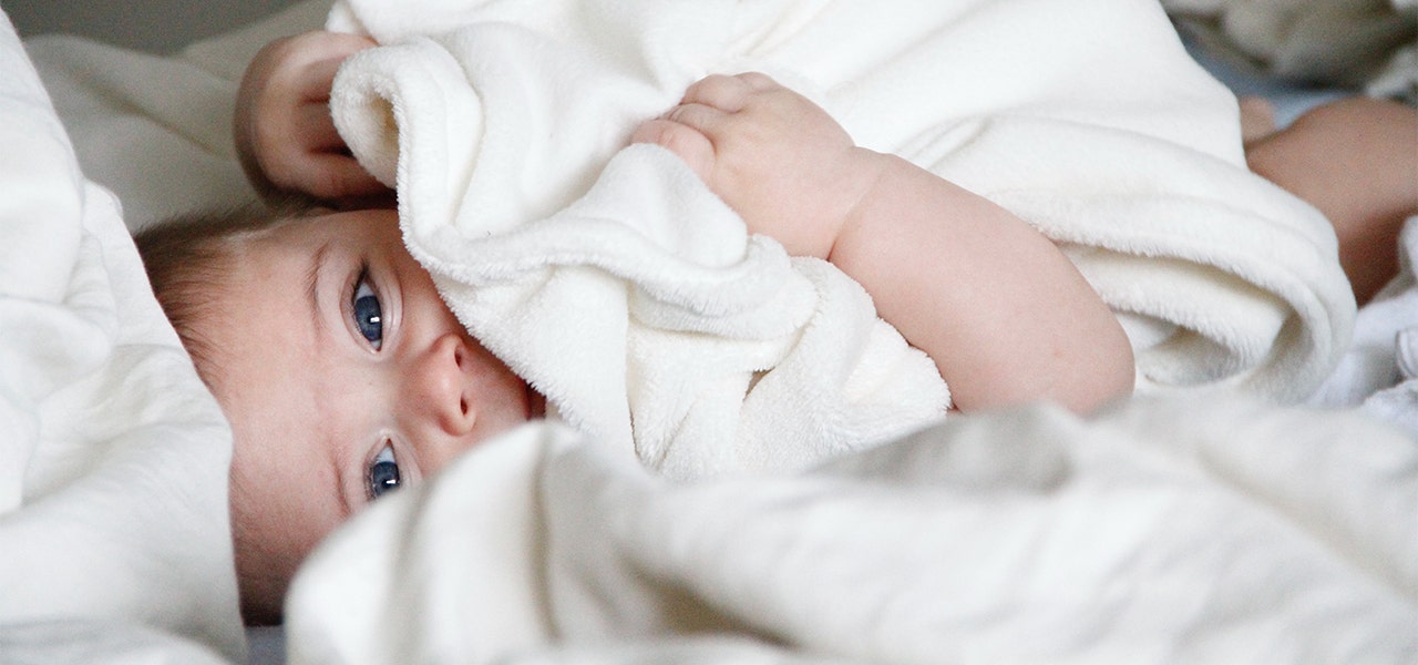 Baby wrapped in a while towel after bath time