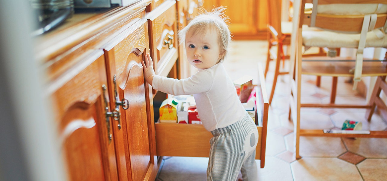 baby opening drawers in the kitchen