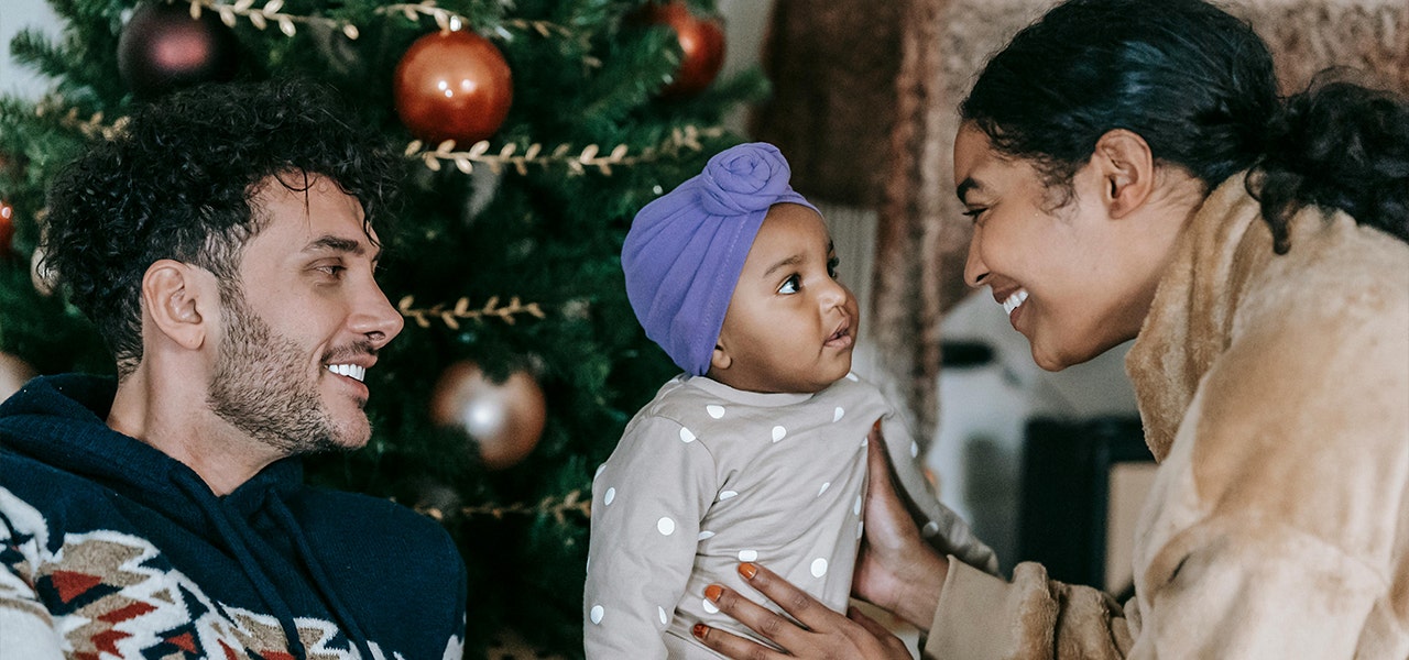 family in front of christmas tree