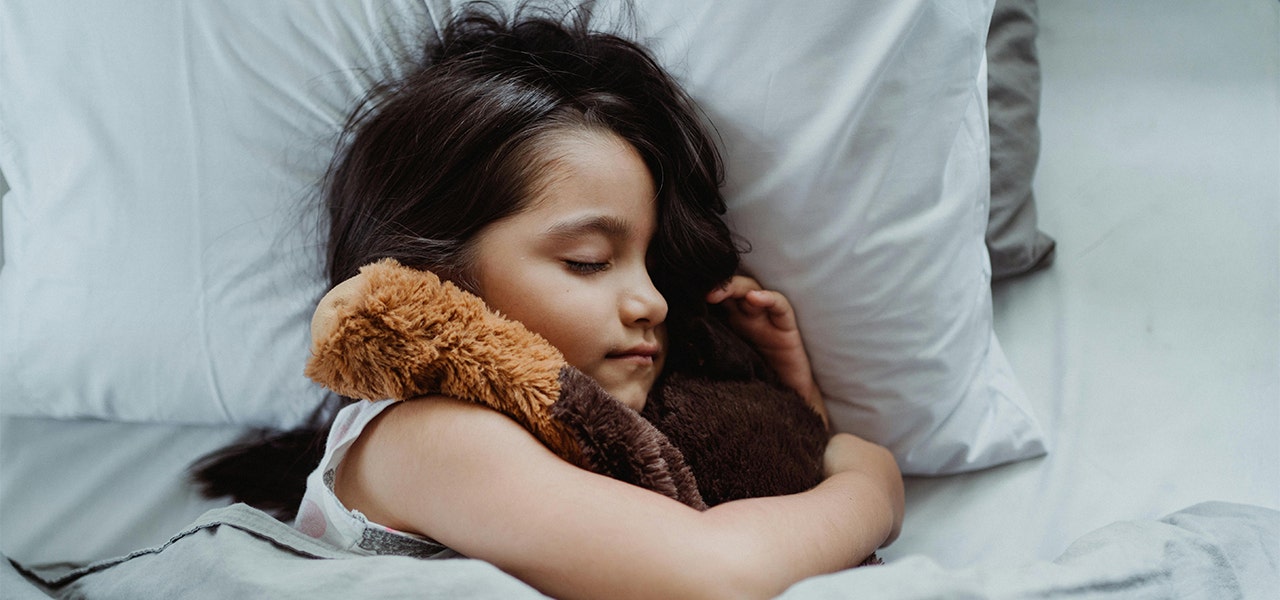 Preschooler sleeping while cuddling a lovey