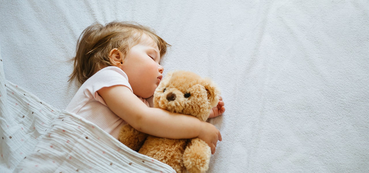 Toddler snuggling a lovey while sleeping