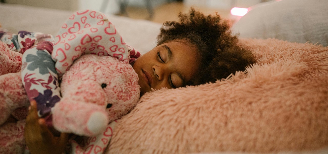 Little girl side-sleeping with her lovey