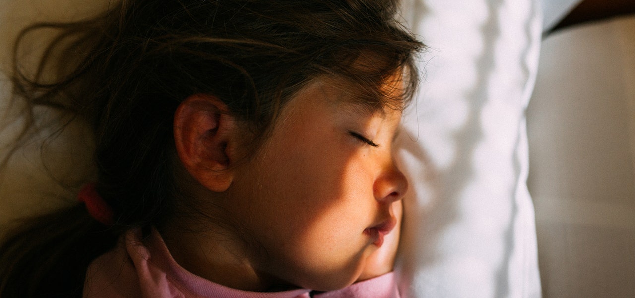Sunlight shining onto sleeping child's face