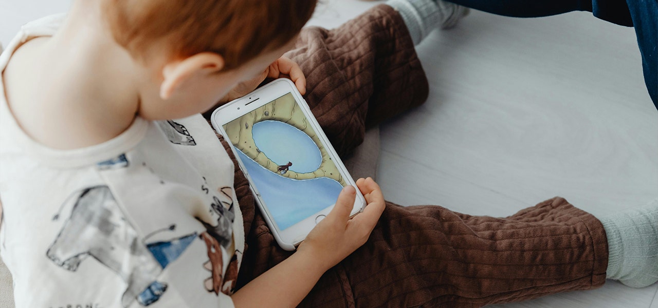 child watching something on an iphone