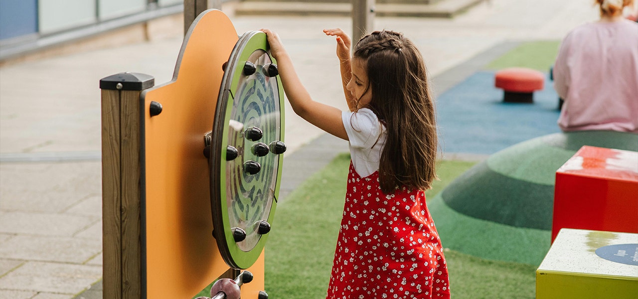 child playing on playground equipment
