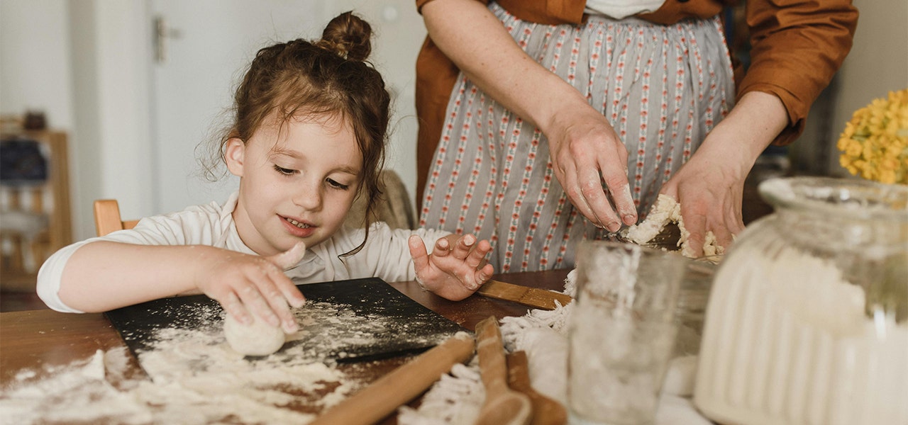 child baking with parent